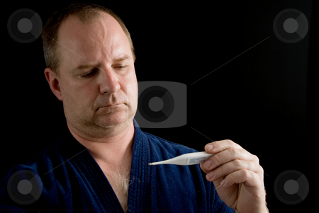 To use this stock image in your creative project, please select the size you need over to the right and click the "Add to Cart" button.
Your downloaded image will come with the Cutcaster watermark removed so don’t worry about the watermark you see on this page. Fever stock photo, A man checking his temperature with a thermometer. by Robert Byron