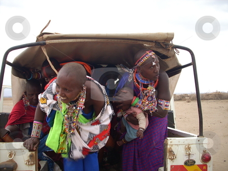 To use this stock image in your creative project, please select the size you need over to the right and click the "Add to Cart" button.
Your downloaded image will come with the Cutcaster watermark removed so don’t worry about the watermark you see on this page. Masai Women with baby hitch a ride stock photo, Masai women with baby hitch a ride in the back of a pick-up by Rose Nthiwa