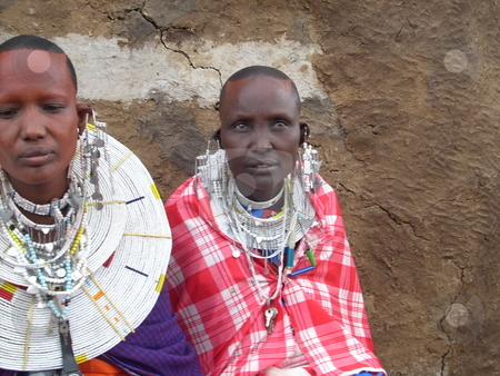 To use this stock image in your creative project, please select the size you need over to the right and click the "Add to Cart" button.
Your downloaded image will come with the Cutcaster watermark removed so don’t worry about the watermark you see on this page. Two Masai women seated side by side stock photo, Two Masai Women seated next to each other infront of Manyatta wall. by Rose Nthiwa