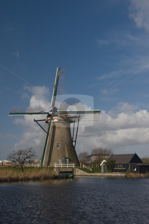 To use this stock image in your creative project, please select the size you need over to the right and click the "Add to Cart" button.
Your downloaded image will come with the Cutcaster watermark removed so don’t worry about the watermark you see on this page. Dutch Windmill and Shed stock photo, Dutch windmill and shed at Kinderdijk, South Holland by Inge Schepers