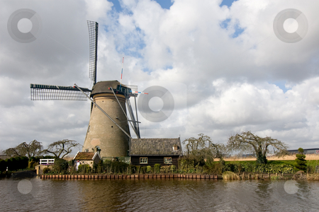 To use this stock image in your creative project, please select the size you need over to the right and click the "Add to Cart" button.
Your downloaded image will come with the Cutcaster watermark removed so don’t worry about the watermark you see on this page. Dutch Windmill and Shed stock photo, Dutch windmill and shed against a background of big clouds by Inge Schepers