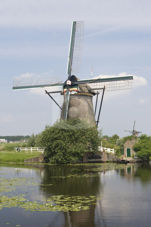 To use this stock image in your creative project, please select the size you need over to the right and click the "Add to Cart" button.
Your downloaded image will come with the Cutcaster watermark removed so don’t worry about the watermark you see on this page. Dutch Windmill stock photo, Dutch windmill with a canal in the foreground by Inge Schepers