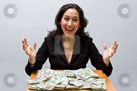 To use this stock image in your creative project, please select the size you need over to the right and click the "Add to Cart" button.
Your downloaded image will come with the Cutcaster watermark removed so don’t worry about the watermark you see on this page. Successful finance stock photo, Happy business woman sitting at a table covered with stacks of money isolated on a white background by Paul Hakimata
