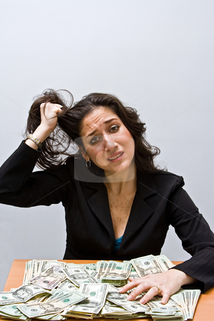 To use this stock image in your creative project, please select the size you need over to the right and click the "Add to Cart" button.
Your downloaded image will come with the Cutcaster watermark removed so don’t worry about the watermark you see on this page. Financial stress stock photo, Business woman pulling hair and stressed about finances. Sitting at a table with lots of money. Isolated on a white background by Paul Hakimata
