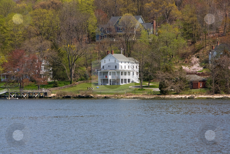 To use this stock image in your creative project, please select the size you need over to the right and click the "Add to Cart" button.
Your downloaded image will come with the Cutcaster watermark removed so don’t worry about the watermark you see on this page. Victorian house stock photo, A remotely located white Victorian mansion on the water and in the woods on a spring day. by Paul Hakimata