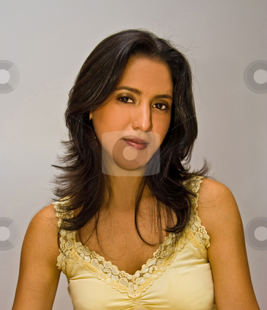 To use this stock image in your creative project, please select the size you need over to the right and click the "Add to Cart" button.
Your downloaded image will come with the Cutcaster watermark removed so don’t worry about the watermark you see on this page. Beautiful Latina stock photo, Beautiful face of a young dark brown haired latina woman wearing a yellow shirt and glossy deep red lips and gold eyeshadow, isolated on white by Paul Hakimata