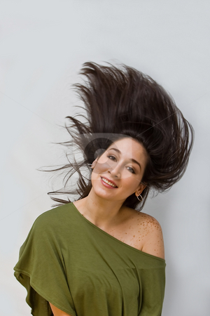 To use this stock image in your creative project, please select the size you need over to the right and click the "Add to Cart" button.
Your downloaded image will come with the Cutcaster watermark removed so don’t worry about the watermark you see on this page. Swinging hair stock photo, Beautiful woman in a green shirt swinging her dark brown hair around, isolated on white by Paul Hakimata