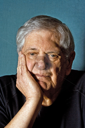 To use this stock image in your creative project, please select the size you need over to the right and click the "Add to Cart" button.
Your downloaded image will come with the Cutcaster watermark removed so don’t worry about the watermark you see on this page. Senior man stock photo, Dramatic portrait of a senior man with his hand on the side of his face wearing a black shirt isolated on gray/blue by Paul Hakimata