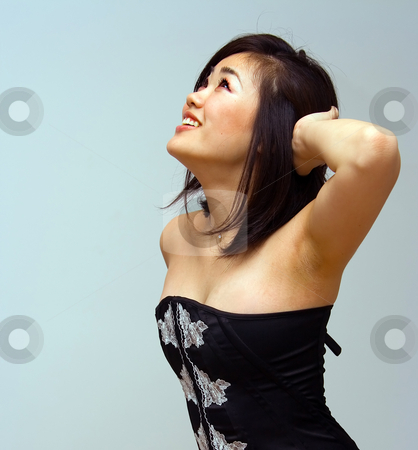 To use this stock image in your creative project, please select the size you need over to the right and click the "Add to Cart" button.
Your downloaded image will come with the Cutcaster watermark removed so don’t worry about the watermark you see on this page. Beautiful sexy Oriental woman stock photo, Beautiful sexy Oriental woman with an attitude looking up by Paul Hakimata