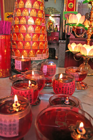 To use this stock image in your creative project, please select the size you need over to the right and click the "Add to Cart" button.
Your downloaded image will come with the Cutcaster watermark removed so don’t worry about the watermark you see on this page. Chinese altar stock photo, Altar in a chinese temple with various offerings and candles by Kheng Guan Toh