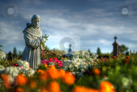 To use this stock image in your creative project, please select the size you need over to the right and click the "Add to Cart" button.
Your downloaded image will come with the Cutcaster watermark removed so don’t worry about the watermark you see on this page. Statue Garden stock photo, A statue located in a cemetery surround by flowers by Richard Nelson
