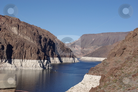 To use this stock image in your creative project, please select the size you need over to the right and click the "Add to Cart" button.
Your downloaded image will come with the Cutcaster watermark removed so don’t worry about the watermark you see on this page. Hoover Dam's Lake Mead stock photo, Lake Mead, the man made lake created by the Hoover Dam in 1935 and source of water for 22 million people in the Southwest, could go dry by 2022 acording to Tim Barnett, a research marine geophysicist with the Schipps Institution of Oceanography. The lake is down 100 feet due to a 20-year drought as shown by the white areas on the surrounding landscape above the dam on the Colorado River (photo February 17, 2008). by Dennis Thomsen