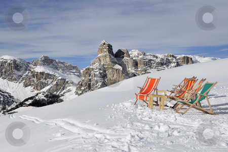 To use this stock image in your creative project, please select the size you need over to the right and click the "Add to Cart" button.
Your downloaded image will come with the Cutcaster watermark removed so don’t worry about the watermark you see on this page. Deck chairs in the snow with the dolomites in the background, It stock photo, Deck chairs in the snow by Csaba Zsarnowszky
