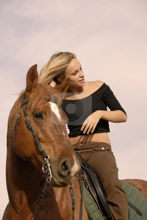 To use this stock image in your creative project, please select the size you need over to the right and click the "Add to Cart" button.
Your downloaded image will come with the Cutcaster watermark removed so don’t worry about the watermark you see on this page. Blond riding girl stock photo, Riding girl and her brown stallion. focus on the teen by Bonzami Emmanuelle