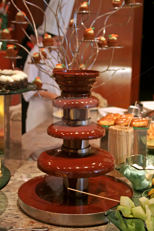 To use this stock image in your creative project, please select the size you need over to the right and click the "Add to Cart" button.
Your downloaded image will come with the Cutcaster watermark removed so don’t worry about the watermark you see on this page. Chocolate, fountain stock photo, Chocolate fountain with fruit to dip in the chocolate by Kheng Guan Toh