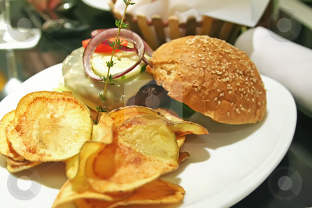 To use this stock image in your creative project, please select the size you need over to the right and click the "Add to Cart" button.
Your downloaded image will come with the Cutcaster watermark removed so don’t worry about the watermark you see on this page. Elegant hamburger stock photo, Gourmet hamburger with chips elegant presentation in a restaurant by Kheng Guan Toh