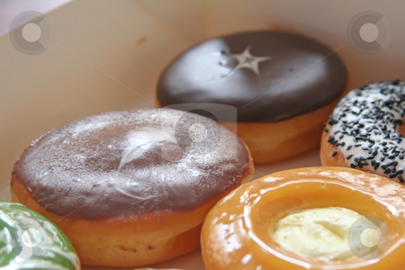 To use this stock image in your creative project, please select the size you need over to the right and click the "Add to Cart" button.
Your downloaded image will come with the Cutcaster watermark removed so don’t worry about the watermark you see on this page. Assorted donuts stock photo, Assorted variety of donuts in a box by Kheng Guan Toh