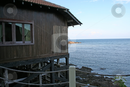 To use this stock image in your creative project, please select the size you need over to the right and click the "Add to Cart" button.
Your downloaded image will come with the Cutcaster watermark removed so don’t worry about the watermark you see on this page. Seaside resort stock photo, Seaside coastline with tropical resort style building by Kheng Guan Toh