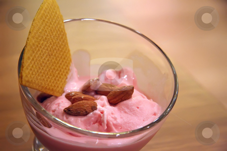 To use this stock image in your creative project, please select the size you need over to the right and click the "Add to Cart" button.
Your downloaded image will come with the Cutcaster watermark removed so don’t worry about the watermark you see on this page. Strawberry icecream stock photo, Pink strawberry icecream with almond topping in glass bowl by Kheng Guan Toh