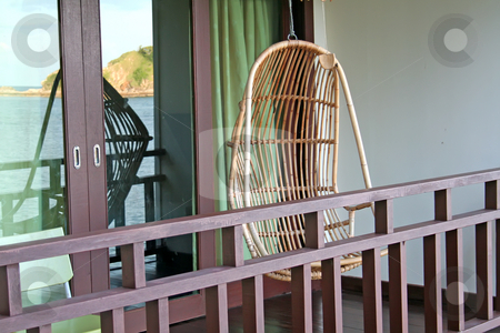To use this stock image in your creative project, please select the size you need over to the right and click the "Add to Cart" button.
Your downloaded image will come with the Cutcaster watermark removed so don’t worry about the watermark you see on this page. Hanging chair stock photo, Hanging chair in a balcony with seaside view by Kheng Guan Toh