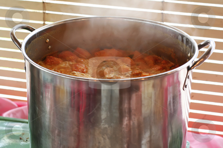 To use this stock image in your creative project, please select the size you need over to the right and click the "Add to Cart" button.
Your downloaded image will come with the Cutcaster watermark removed so don’t worry about the watermark you see on this page. Pot of curry stock photo, A pot of spicy curry simmering in a metal pot by Kheng Guan Toh