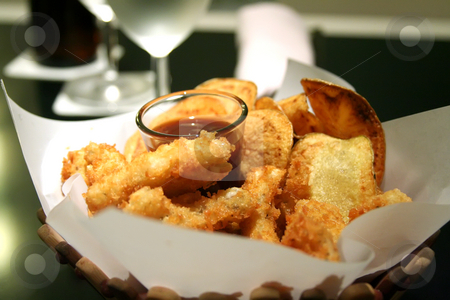 To use this stock image in your creative project, please select the size you need over to the right and click the "Add to Cart" button.
Your downloaded image will come with the Cutcaster watermark removed so don’t worry about the watermark you see on this page. Snack basket stock photo, Snack basket of fried calamari and potato chips restaurant setting by Kheng Guan Toh