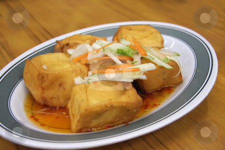 To use this stock image in your creative project, please select the size you need over to the right and click the "Add to Cart" button.
Your downloaded image will come with the Cutcaster watermark removed so don’t worry about the watermark you see on this page. Fried tofu stock photo, Chinese cuisine dish of fried tofu in gravy by Kheng Guan Toh