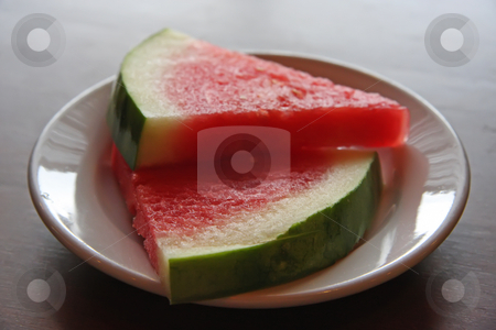 To use this stock image in your creative project, please select the size you need over to the right and click the "Add to Cart" button.
Your downloaded image will come with the Cutcaster watermark removed so don’t worry about the watermark you see on this page. Sliced watermelon stock photo, Cut red watermelon slices on a white plate by Kheng Guan Toh