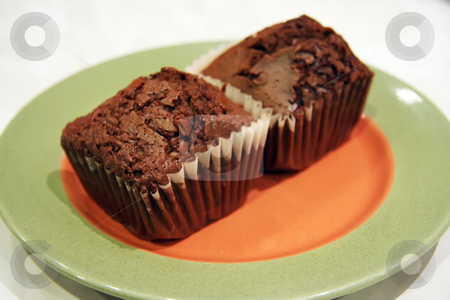 To use this stock image in your creative project, please select the size you need over to the right and click the "Add to Cart" button.
Your downloaded image will come with the Cutcaster watermark removed so don’t worry about the watermark you see on this page. Chocolate muffins stock photo, Two chocolate muffins on an orange and green plate by Kheng Guan Toh