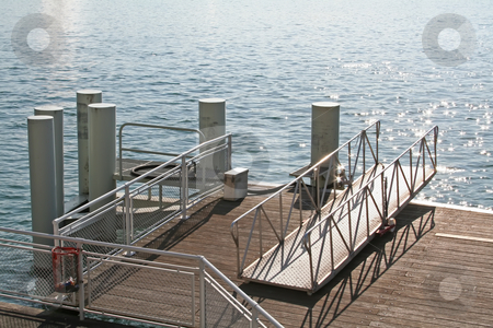 To use this stock image in your creative project, please select the size you need over to the right and click the "Add to Cart" button.
Your downloaded image will come with the Cutcaster watermark removed so don’t worry about the watermark you see on this page. Wooden pier stock photo, Pier with wooden walkway next to water by Kheng Guan Toh