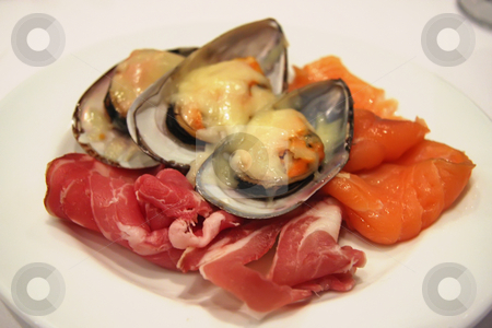 To use this stock image in your creative project, please select the size you need over to the right and click the "Add to Cart" button.
Your downloaded image will come with the Cutcaster watermark removed so don’t worry about the watermark you see on this page. Appetizer plate stock photo, Appetizer plate of spanish ham smoked salmon and baked mussels by Kheng Guan Toh
