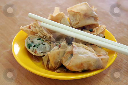 To use this stock image in your creative project, please select the size you need over to the right and click the "Add to Cart" button.
Your downloaded image will come with the Cutcaster watermark removed so don’t worry about the watermark you see on this page. Fried dimsum stock photo, Fried dimsum in plate with chopsticks chinese food by Kheng Guan Toh