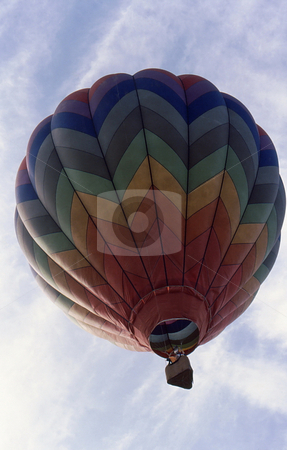 To use this stock image in your creative project, please select the size you need over to the right and click the "Add to Cart" button.
Your downloaded image will come with the Cutcaster watermark removed so don’t worry about the watermark you see on this page. Hot Air Balloon ascending stock photo, brightly colored hot air Balloon ascending into a coludy sky by Joseph Ligori
