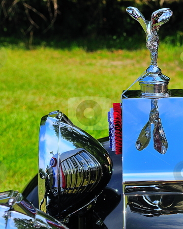 To use this stock image in your creative project, please select the size you need over to the right and click the "Add to Cart" button.
Your downloaded image will come with the Cutcaster watermark removed so don’t worry about the watermark you see on this page. Flying lady stock photo, Rolls royce flying lady reflected on radiator and headlamp by Tim Doubrava