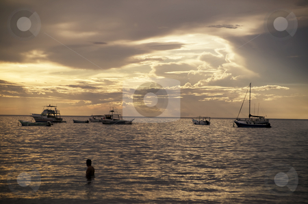 To use this stock image in your creative project, please select the size you need over to the right and click the "Add to Cart" button.
Your downloaded image will come with the Cutcaster watermark removed so don’t worry about the watermark you see on this page. Boats at Sunset in Costa Rica stock photo, Costa Rica sunset with Boats and single bather in the Pacific Ocean by Scott Griessel