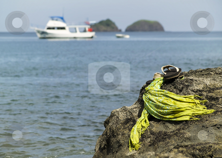 To use this stock image in your creative project, please select the size you need over to the right and click the "Add to Cart" button.
Your downloaded image will come with the Cutcaster watermark removed so don’t worry about the watermark you see on this page. Sandals by the shore stock photo, Sandals on a rock with ocean and boat in the background by Scott Griessel