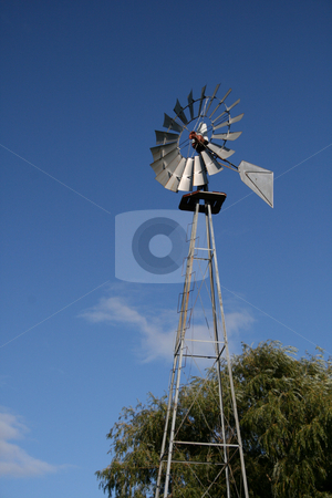 To use this stock image in your creative project, please select the size you need over to the right and click the "Add to Cart" button.
Your downloaded image will come with the Cutcaster watermark removed so don’t worry about the watermark you see on this page. Windmill and Blue Sky stock photo, A vintage towering windmill set against a brilliant blue sky. by Betty Hansen