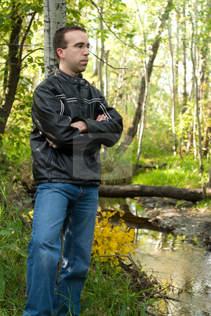 To use this stock image in your creative project, please select the size you need over to the right and click the "Add to Cart" button.
Your downloaded image will come with the Cutcaster watermark removed so don’t worry about the watermark you see on this page. Man Relaxing By A Stream stock photo, A young man leaning against a tree and relaxing by a stream by Richard Nelson