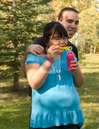 To use this stock image in your creative project, please select the size you need over to the right and click the "Add to Cart" button.
Your downloaded image will come with the Cutcaster watermark removed so don’t worry about the watermark you see on this page. Playing stock photo, A nine year old girl and her dad, blowing bubbles outside by Richard Nelson