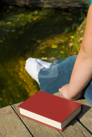 To use this stock image in your creative project, please select the size you need over to the right and click the "Add to Cart" button.
Your downloaded image will come with the Cutcaster watermark removed so don’t worry about the watermark you see on this page. Relaxing Outside stock photo, Someone sitting on a wood dock with their feet over the edge by Richard Nelson