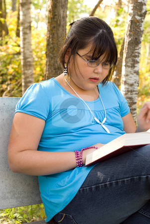To use this stock image in your creative project, please select the size you need over to the right and click the "Add to Cart" button.
Your downloaded image will come with the Cutcaster watermark removed so don’t worry about the watermark you see on this page. Reading Outside stock photo, A nine year old girl reading a book outside by Richard Nelson