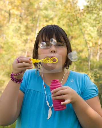 To use this stock image in your creative project, please select the size you need over to the right and click the "Add to Cart" button.
Your downloaded image will come with the Cutcaster watermark removed so don’t worry about the watermark you see on this page. Outdoor Fun stock photo, Nine year old girl blowing bubbles outside by Richard Nelson