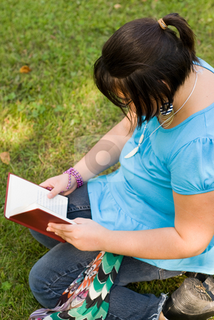 To use this stock image in your creative project, please select the size you need over to the right and click the "Add to Cart" button.
Your downloaded image will come with the Cutcaster watermark removed so don’t worry about the watermark you see on this page. Child Reading A Novel stock photo, A young girl reading a novel outside by Richard Nelson