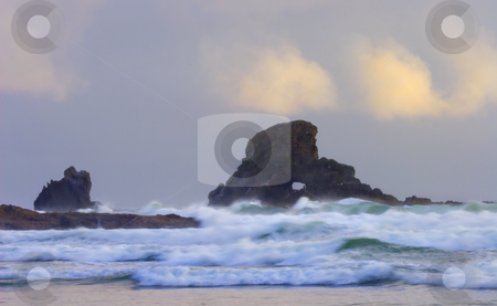To use this stock image in your creative project, please select the size you need over to the right and click the "Add to Cart" button.
Your downloaded image will come with the Cutcaster watermark removed so don’t worry about the watermark you see on this page. Consumed by the Sea stock photo, A arch carved in this seastack off the ORegon near Ecola State Park engulfed by the rising tides. by Mike Dawson
