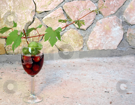 To use this stock image in your creative project, please select the size you need over to the right and click the "Add to Cart" button.
Your downloaded image will come with the Cutcaster watermark removed so don’t worry about the watermark you see on this page. Vine shoot over wine glass stock photo, Green young vine shoot with red wine glass over stone fence by Julija Sapic