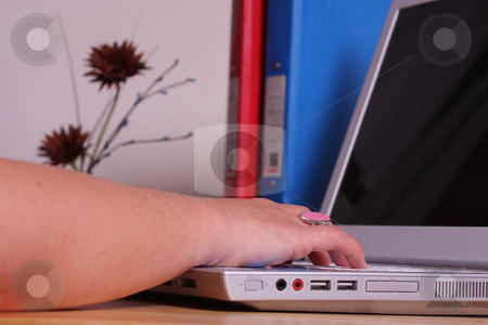 To use this stock image in your creative project, please select the size you need over to the right and click the "Add to Cart" button.
Your downloaded image will come with the Cutcaster watermark removed so don’t worry about the watermark you see on this page. Working on a laptop in office stock photo, A lady working in an office or home office on her laptop, binders and a plant ornament on her desk. by Mark Allchin