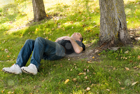 To use this stock image in your creative project, please select the size you need over to the right and click the "Add to Cart" button.
Your downloaded image will come with the Cutcaster watermark removed so don’t worry about the watermark you see on this page. Dreaming Under A Tree stock photo, Man lying under a tree in the shade by Richard Nelson