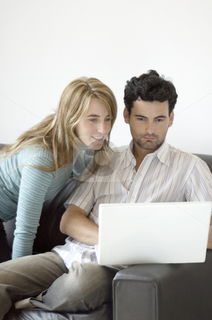 To use this stock image in your creative project, please select the size you need over to the right and click the "Add to Cart" button.
Your downloaded image will come with the Cutcaster watermark removed so don’t worry about the watermark you see on this page. Couple sharing time with a laptop at home stock photo, Young professional man working at home with his laptop on the sofa and his partner looking on. by Lee Torrens