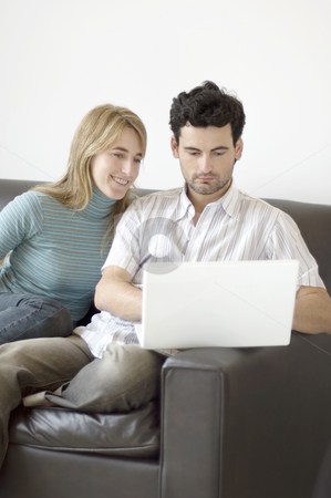 To use this stock image in your creative project, please select the size you need over to the right and click the "Add to Cart" button.
Your downloaded image will come with the Cutcaster watermark removed so don’t worry about the watermark you see on this page. Couple relaxing at home with a laptop computer stock photo, A young couple relaxing at home on the sofa with a laptop computer by Lee Torrens