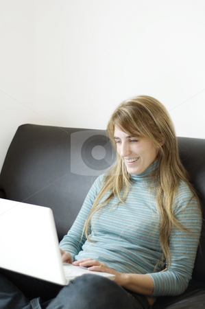 To use this stock image in your creative project, please select the size you need over to the right and click the "Add to Cart" button.
Your downloaded image will come with the Cutcaster watermark removed so don’t worry about the watermark you see on this page. Woman sitting on sofa using laptop stock photo, A young woman relaxing with her laptop at home by Lee Torrens